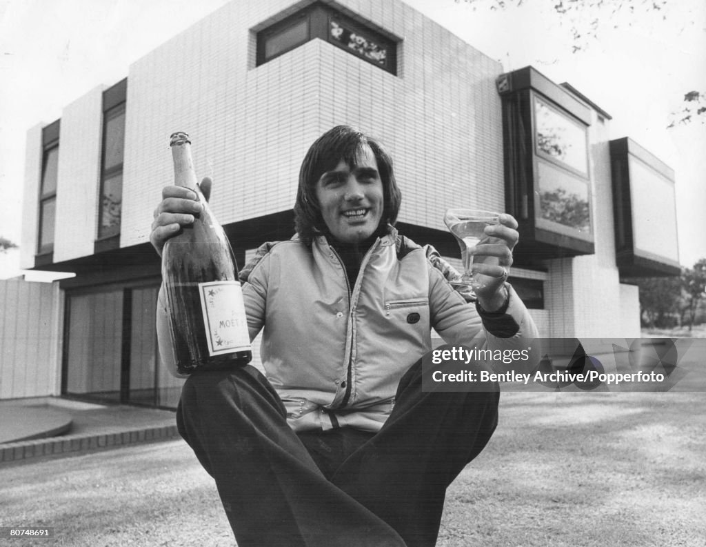 FootballGeorge Best holds a bottle of champagne as he prepares for a party to celebrate the sale of his house in Cheshire, September 1972.