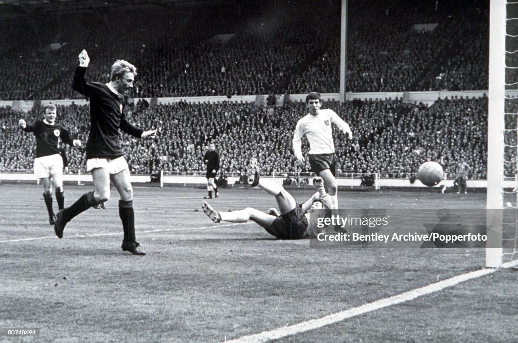 International Football Wembley Stadium. 1967. England 2 v Scotland 3. Scotland's Denis Law beats England goalkeeper Gordon Banks to score the first goal .