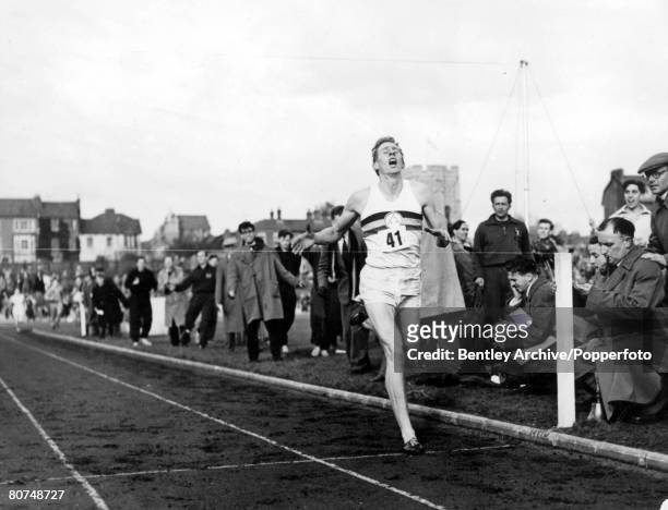 Athletics, Oxfordshire, England, 6th May Roger Bannister breaks the tape as he crosses the winning line to complete the historic four minute mile...