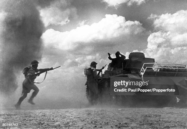 War and Conflict, World War 2, pic: 1942, The Battle of El Alamein, A German tank is knocked out and British troops rush up with fixed bayonets to...