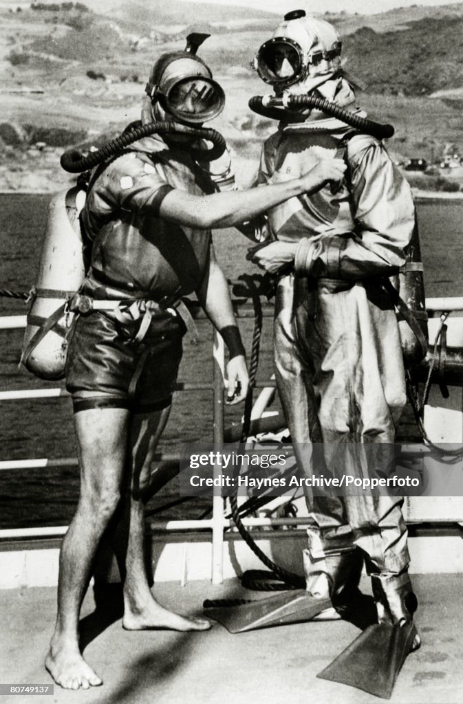 Underwater Exploration Personalities. pic: 25th October 1950. Diver Terry Young, left, and French diver Jacques Yves Cousteau who were the co-inventors of the new French diving lung which Cousteau is wearing which was being tested at San Pedro by the Uni