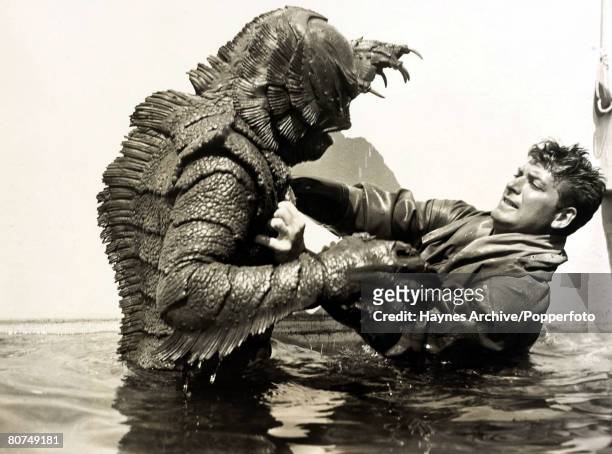 Cinema Personalities, pic: 1955, American actor John Agar, appearing in the film "Revenge of the Creature" fighting off the "Gill Man"