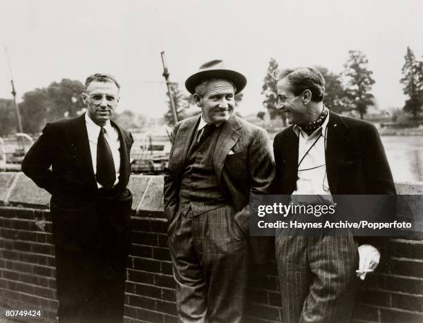 Cinema, England, American film actor Spencer Tracey, centre, with director George Cukor, left, and photographer director Freddie Young during a break...