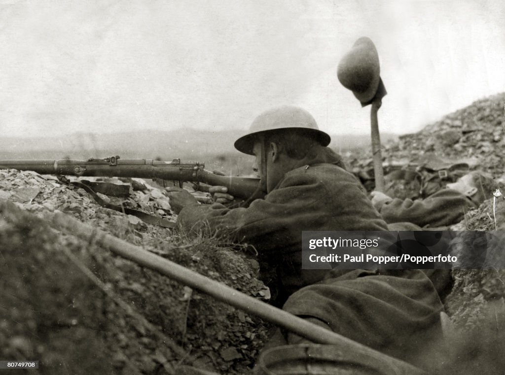 War and Conflict World War I. (1914-1918) Greece. A British soldier takes aim as a colleague tries to draw fire from a Bulgarian position at Salonika.