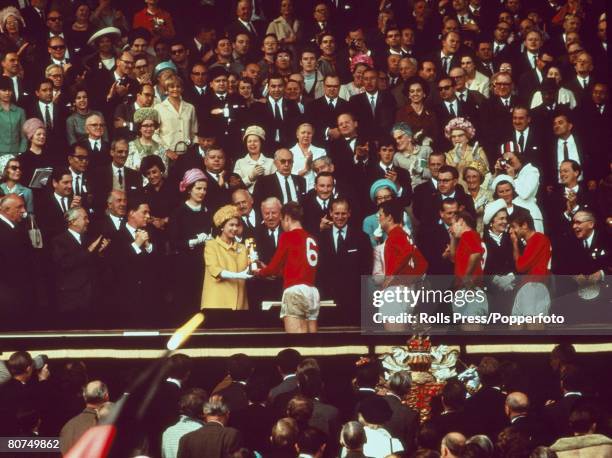 World Cup Final Wembley Stadium, England, 30th July England 4 v West Germany 2, England captain Bobby Moore receives the trophy from HRH Queen...