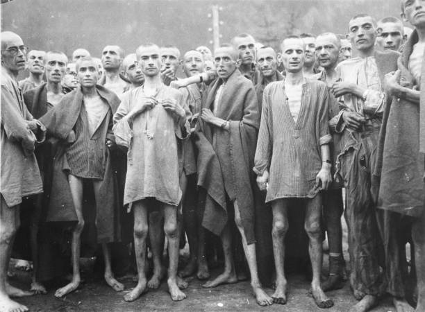 Starved prisoners, nearly dead from hunger, pose in concentration camp May 7, 1945 in Ebensee, Austria. The camp was reputedly used for "scientific"...