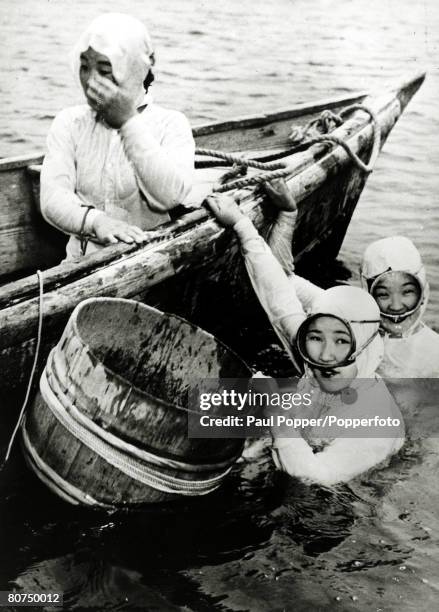 Japan, Professions, pic: circa 1950, Japanese girl divers who collect oysters from the sea and river estuaries pictured at work, with the containers...