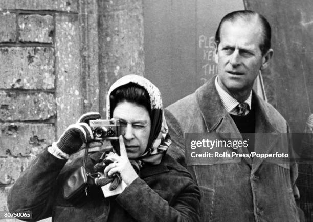 27th April 1974, Badminton, Gloucestershire, HM, Queen Elizabeth using her camera alongside the Duke of Edinburgh at the Badminton Horse Trials