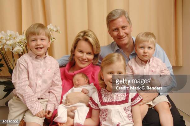 In this handout photo provided by the Royal Palace, Princess Mathilde and Prince Philippe of Belgium pose for a photo with newborn baby daughter...