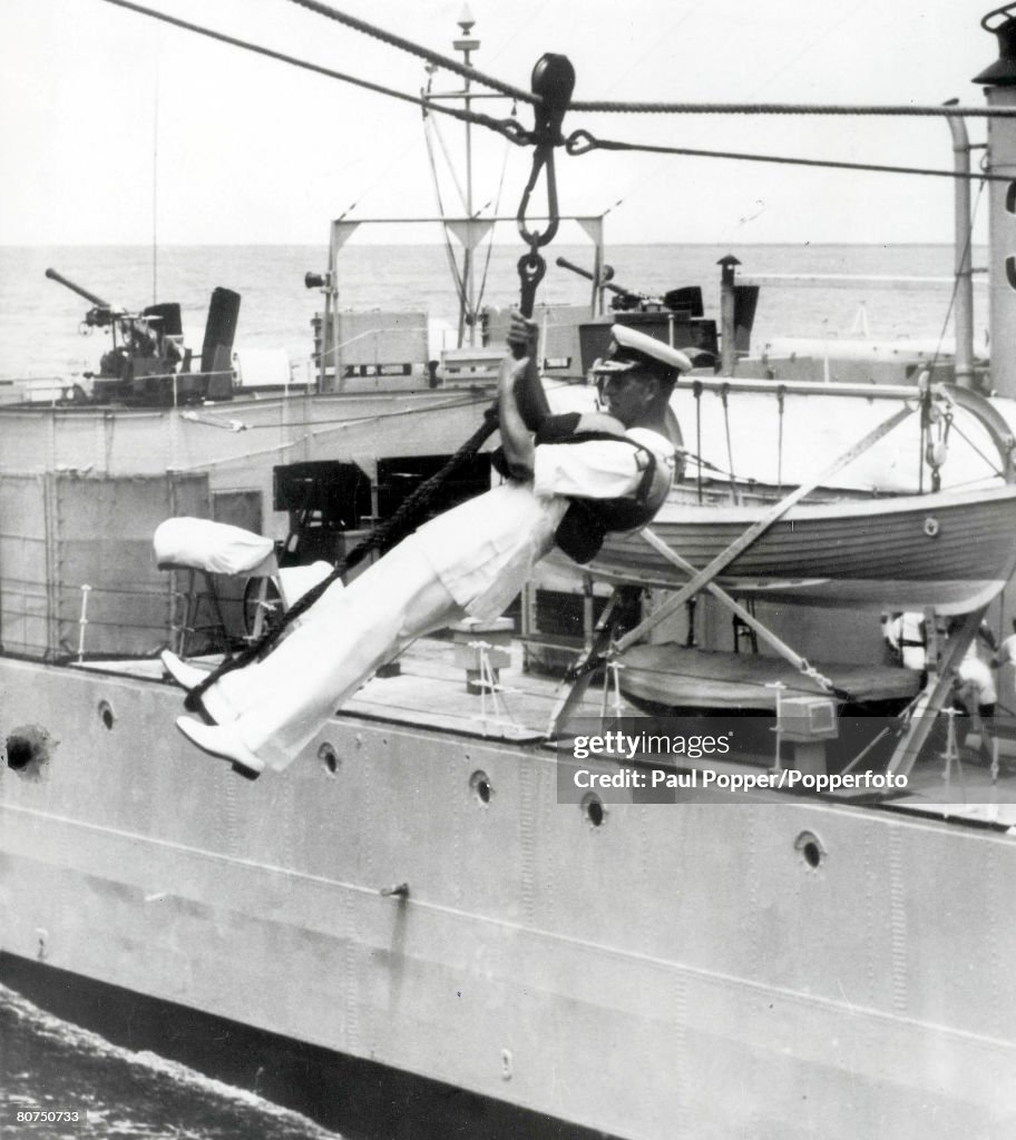 Royalty 9th April 1959. The Duke of Edinburgh, Prince Philip, pictured in mid-air as he transfers from the Royal Yacht Britannia to the Royal New Zealand frigate "Rotoiti" during the voyage from the Solomon Isles to the Gilbert and Ellice Islands in the