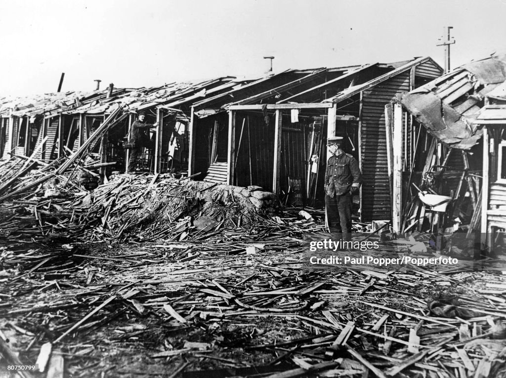 Volume 2 Page 124. Picture 10. World War One. 1914 - 1918. May, 1918. Western front. Etaples. A soldier inspects the extensive bomb damage to the St. John's Ambulance Brigade hospital building after it had been attacked by Nazi bombers in an air raid.