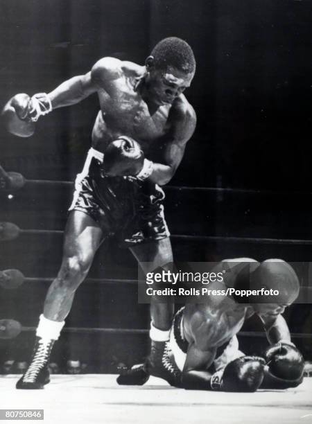 May 1965, Nigerian born boxer Dick Tiger, the former Middleweight Champion of the World, stands over Rubin "Hurricane" Carter after knocking him to...