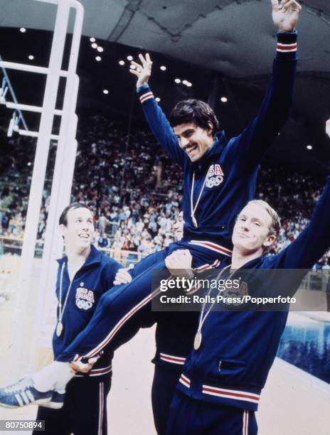 American swimmer Mark Spitz is lifted up by his team-mates after winning one of his seven gold medals in the pool during competition for the United...