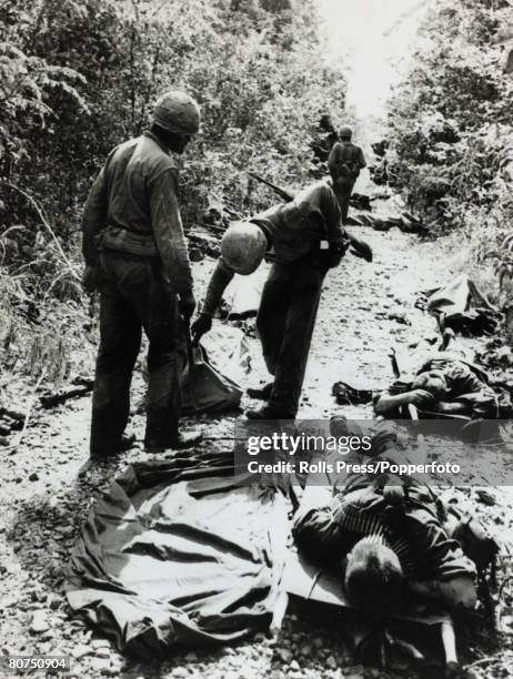War and Conflict, The Vietnam War, pic: December 1965, Michelin Plantation, South Vietnam, Dead and wounded Americans on a jungle track after a Viet...