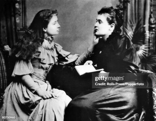 American writer Helen Keller who became deaf and blind at 19 months, pictured as she feels the face of her "teacher" Anne Sullivan, who was a great...