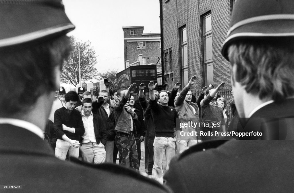 People Demonstrations. pic: 29th April 1979. London. National Front supporters give the Nazi salute through a cordon of policemen, aimed towards marchers on an anti National Front demo in East London.