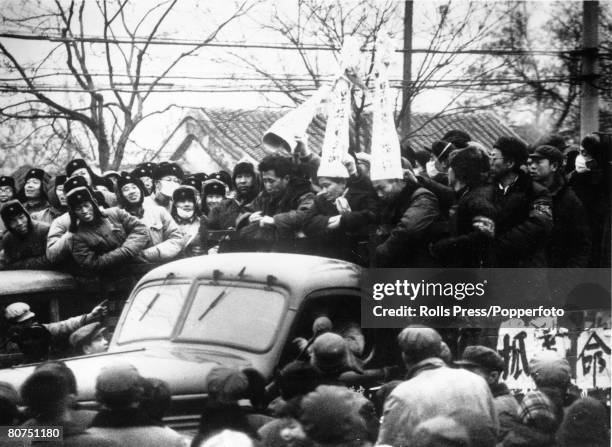 Demonstrations, China, Peking, February 1967, Three followers of the "bourgeois reactionary line" are paraded through Peking's streets wearing dunces...