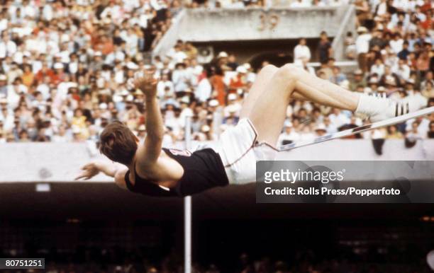 American high jumper Dick Fosbury in action using his revolutionary back-first Fosbury Flop technique to finish in first place to win the gold medal...