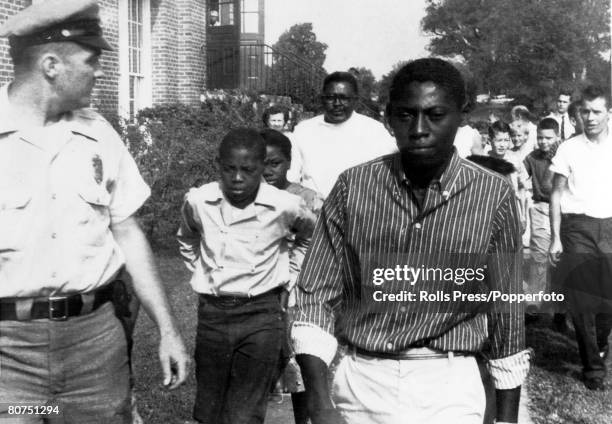 Education, Segregation, USA, pic: 3rd September 1957, Greensboro, North Carolina, Black students, escorted by a policeman calmly pass a crowd of...