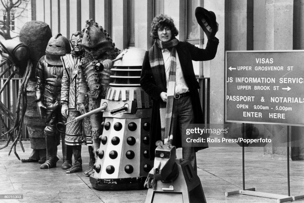 Stage and Screen Personalities. pic: 14th February 1978. Actor Tom Baker, Dr. Who of the TV. series, pictured at the US. Embassy, in London, with a Dalek and other Dr. Who characters. Tom Baker was there to apply for a US. visa as the BBC were making a b