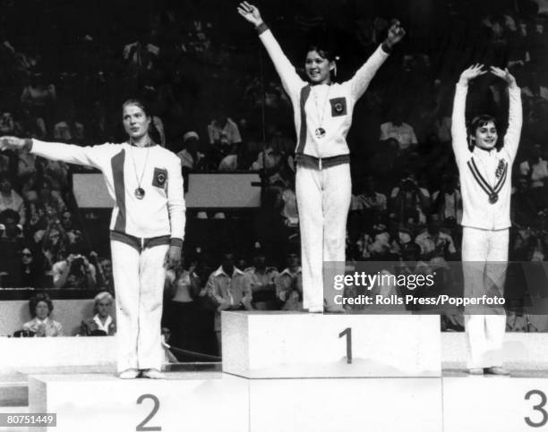 Gymnasts, from left, silver medallist Ludmila Tourischeva of the Soviet Union, gold medallist Nellie Kim of the Soviet Union and bronze medallist...