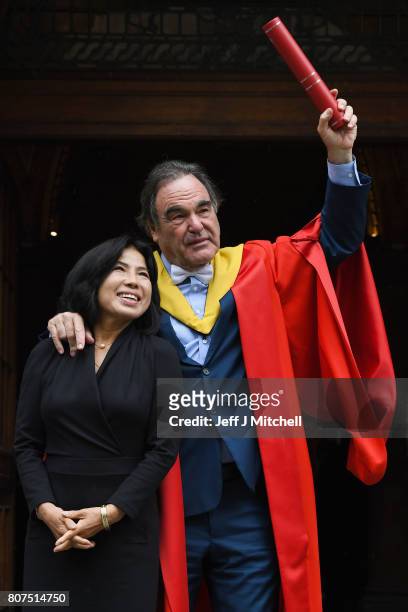 Academy award winning film director Oliver Stone and his wife Chong Stone, pose following receiving his honorary degree from the University of...