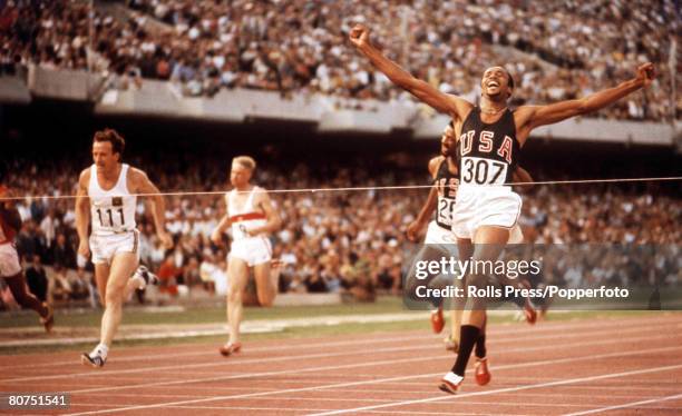 American track and field athlete Tommie Smith of the United States team crosses the finish line in first place, in a world record time of 19.83...