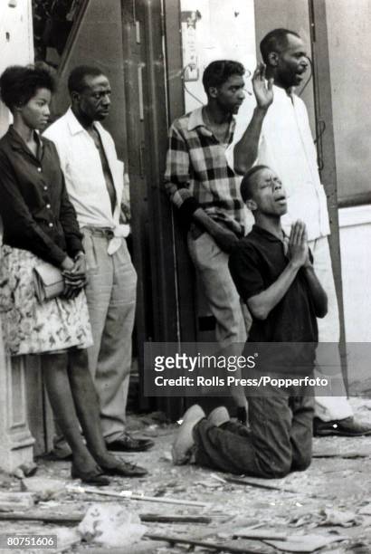 Race Relations, USA, pic: 16th September 1963, Birmingham, Alabama, A black youth kneels in prayer, alongside other solemn people, after a baptist...