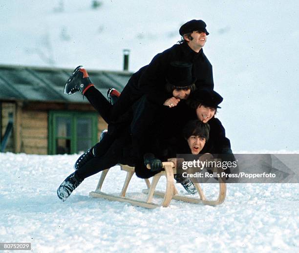 The Beatles, Ringo Starr, George Harrison , John Lennon and Paul McCartney, all piled on top of a sledge in the snow during the making of their...