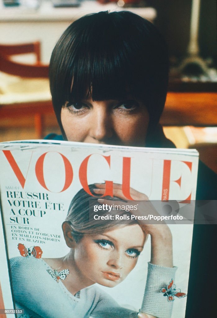 Fashion 1967. London. Famous fashion designer Mary Quant reads a copy of "Vogue" magazine, featuring Twiggy on the front cover, in her London boutique .