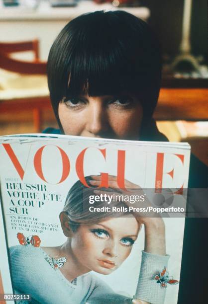 Fashion London, Famous fashion designer Mary Quant reads a copy of "Vogue" magazine, featuring Twiggy on the front cover, in her London boutique