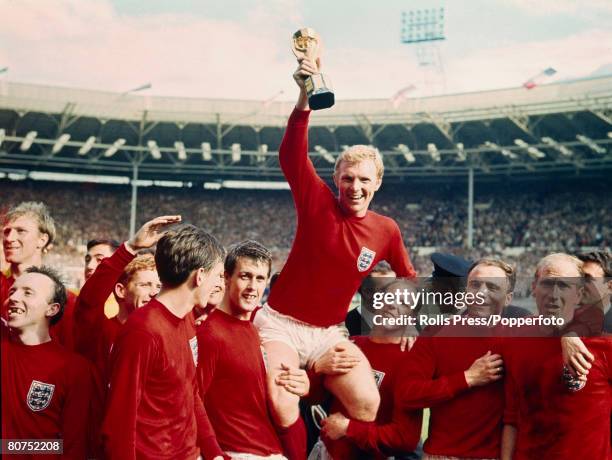 30th July 1966, 1966 World Cup Final at Wembley, England 4 v West Germany 2 a,e,t, England captain Bobby Moore holds aloft the World Cup as the team,...
