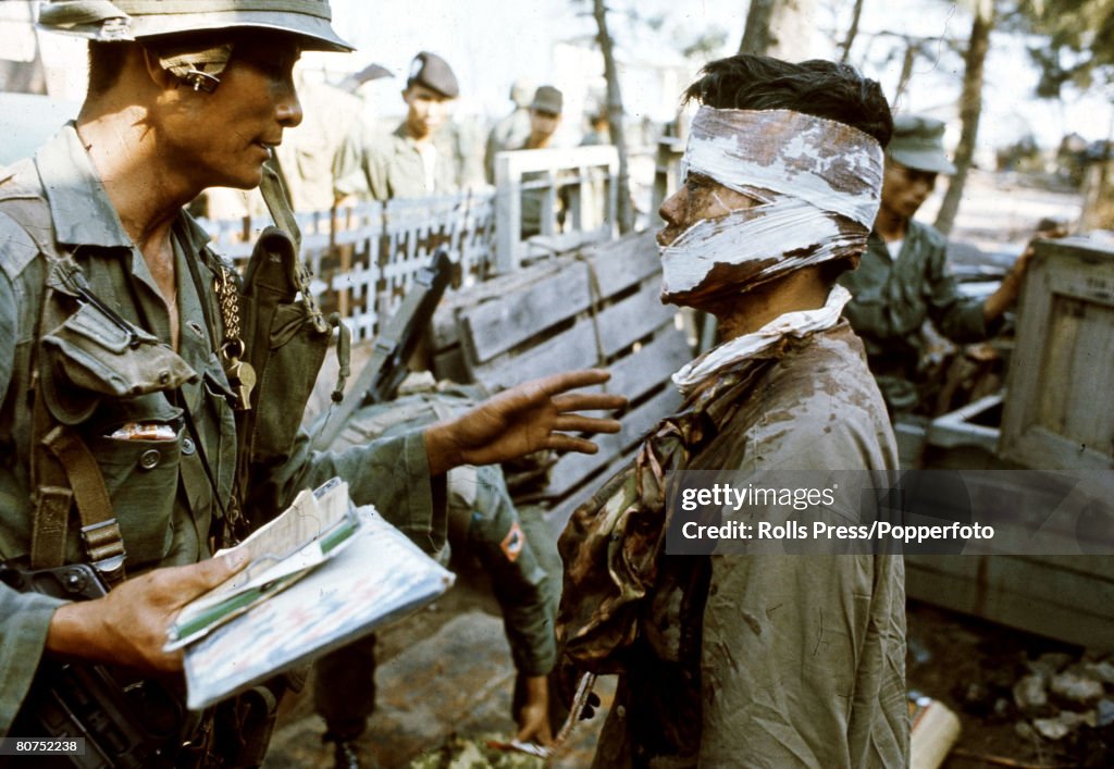 War and Conflict The Vietnam War. pic: 1968. Hue, South Vietnam. A wounded, blood-soaked Viet Cong is questioned by a South Vietnamese soldier during the bitter fighting for the city of Hue.
