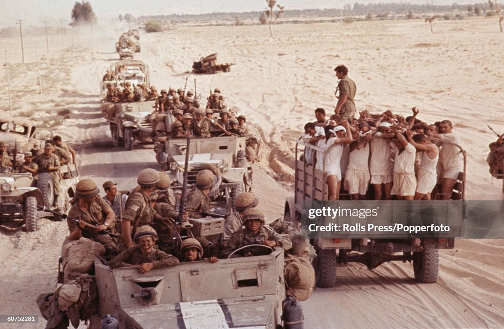 Middle East 8th June 1967. Six Day War. Sinai Desert. Captured Egyptian soldiers are transported in an open top truck to a prisoner of war camp (POW) as an Israeli armoured convoy moves through the desert after capturing El Arish.