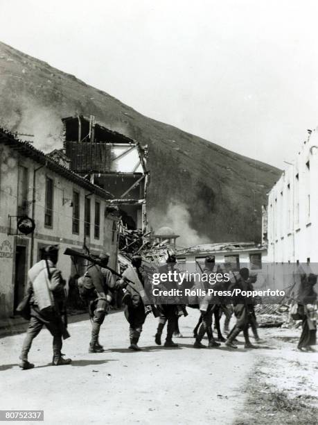 War and Conflict, Spanish Civil War , pic: Rebel soldiers in the streets of Santander as they are met by wrecked and smouldering buildings destroyed...