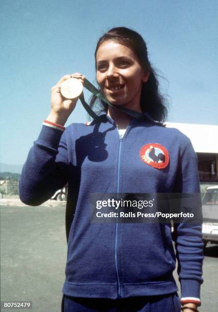 French athlete Colette Besson of the France team shows off her gold medal after finishing in forst place in the final of the Women's 400 metres event...