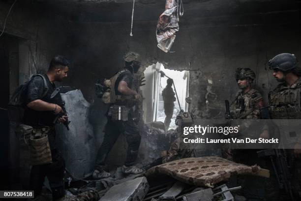 Iraqi soldiers advance through a hole they created in al-Nuri mosque district of Mosul's Old City on June 29, 2017. The Iraqi Army, Special...