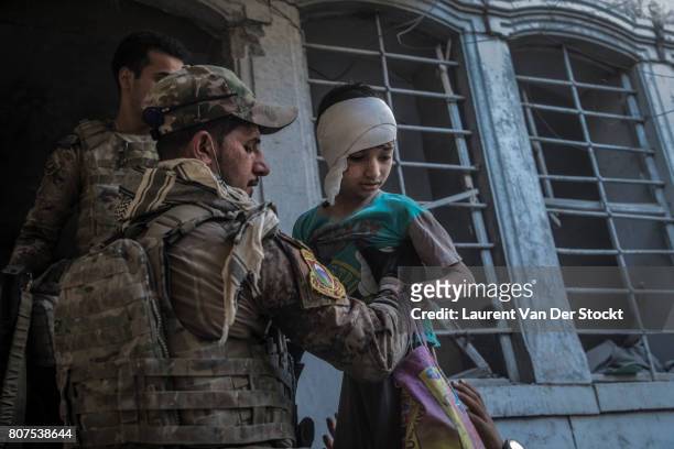 Iraqi forces evacuate a boy and his family that they discovered in al-Nuri mosque complex on June 29 in Mosul, Iraq. The Iraqi Army, Special...