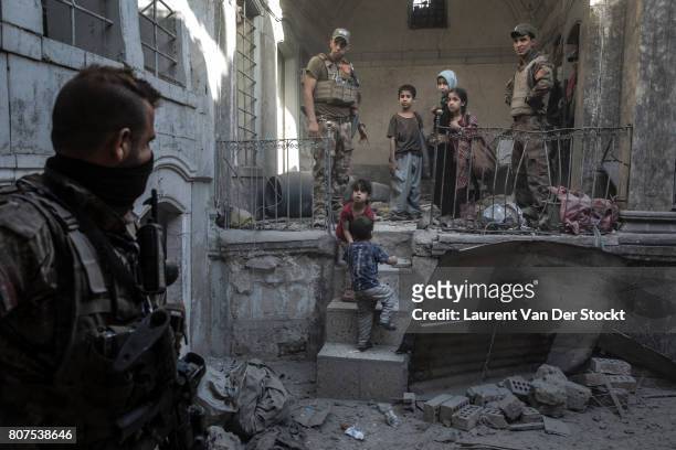 Iraqi forces evacuate a family they discovered in al-Nuri mosque complex on June 29 in Mosul, Iraq. The Iraqi Army, Special Operations Forces and...