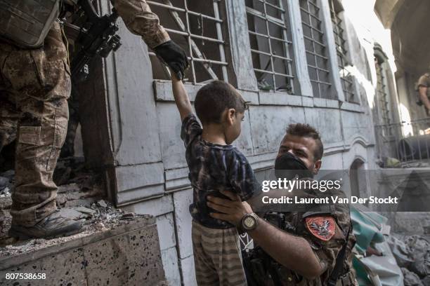 Iraqi forces evacuate a boy and his family they discovered in al-Nuri mosque complex on June 29 in Mosul, Iraq. The Iraqi Army, Special Operations...