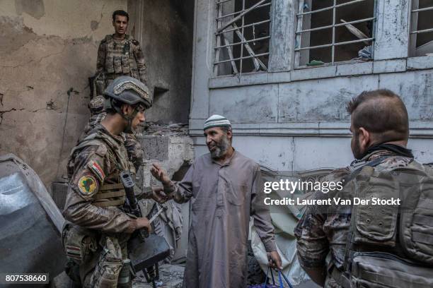 Iraqi forces question a man they suspect of being affiliated with the Islamic State in al-Nuri mosque complex on June 29 in Mosul, Iraq. The Iraqi...