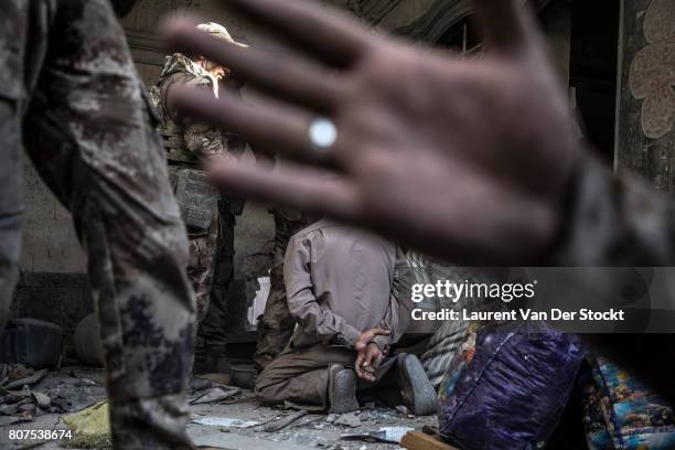 Iraqi forces interrogate two men they suspect of being affiliated with the Islamic State in al-Nuri mosque complex on June 29 in Mosul, Iraq. They...