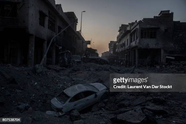 The cratered roadway of Farouk street at night in the Old City of Mosul, near Al Nuri mosque. The Iraqi Army, Special Operations Forces and...