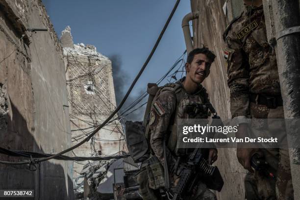 Iraqi soldiers pass the base of the destroyed Hadba minaret in al-Nuri mosque complex on June 29 in Mosul, Iraq. The Iraqi Army, Special Operations...