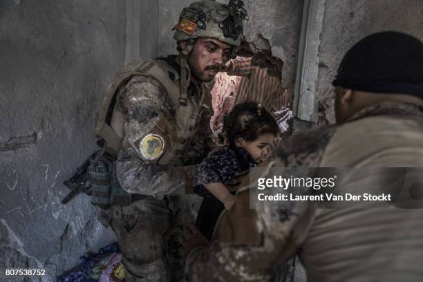 Iraqi soldiers rescue children from a room in al-Nuri mosque complex on June 29 in Mosul, Iraq. The Iraqi Army, Special Operations Forces and...