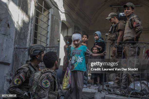 Iraqi soldiers evacuate a family they discovered in al-Nuri mosque complex on June 29 in Mosul, Iraq. The Iraqi Army, Special Operations Forces and...