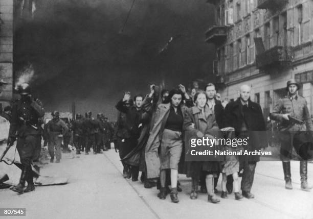 Jewish civilians are forced to march by SS soldiers in this 1943 photo during the destruction of the Warsaw Ghetto in Poland.