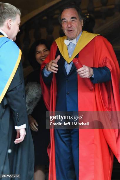 Academy award winning film director Oliver Stone and his wife Chong Stone, pose following receiving his honorary degree from the University of...