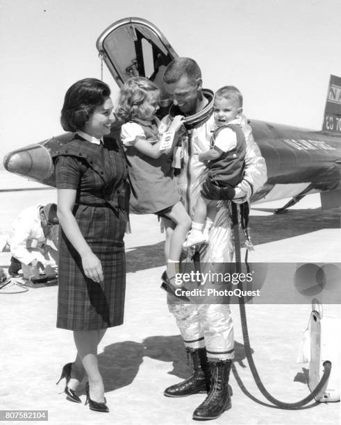 Air Force pilot Captain Joe H Engle poses with his wife and their children, Laurie and Joe Jr, after his eight-minute familiarization flight in the...