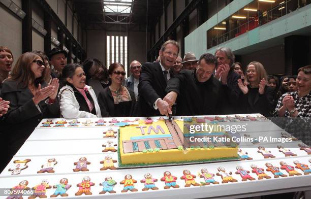 Tate Director Nicholas Serota and Tate Modern Director Vicente Todoli cut the Tate Modern 10th Birthday cake surrounded by artists including Tracey...